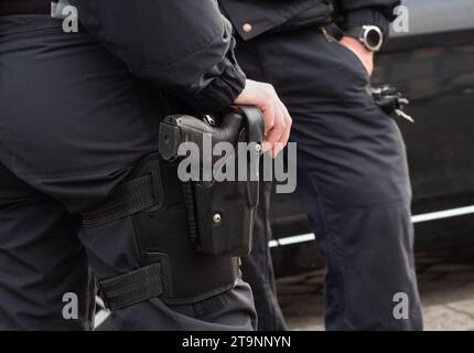 Berlin, Deutschland. November 2023. 19.11.2023, Berlin. Ein Polizist steht neben einem Kollegen mit der Hand auf dem Pistolenholster. Kredit: Wolfram Steinberg/dpa Kredit: Wolfram Steinberg/dpa/Alamy Live News Stockfoto