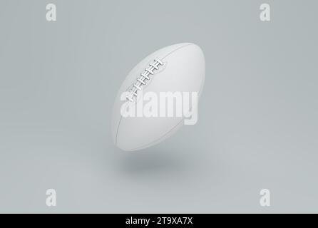 Weißer American Football Ball auf grauem Studio Hintergrund. Minimales Konzept. Schwarzweiß. 3D-Rendering. Stockfoto