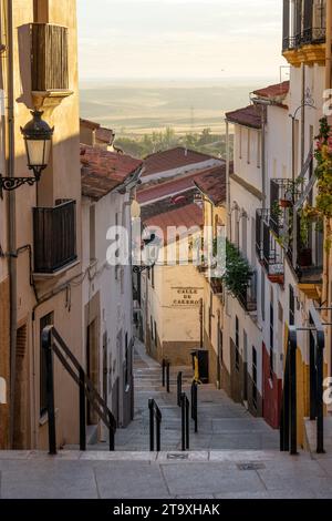 Wunderschöne Cuesta del Maestre Straße bei Sonnenuntergang mit typischen Häusern im alten Zwillingsviertel von Caceres, Weltkulturerbe von Stockfoto