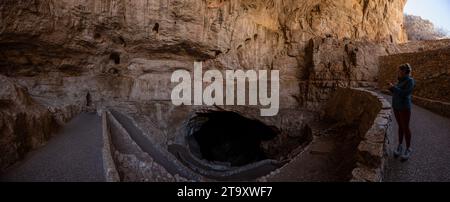 Frau schaut hinunter in den Eingang der Carlsbad Caverns auf dem Weg hinunter zur Natural Entrance Tour Stockfoto