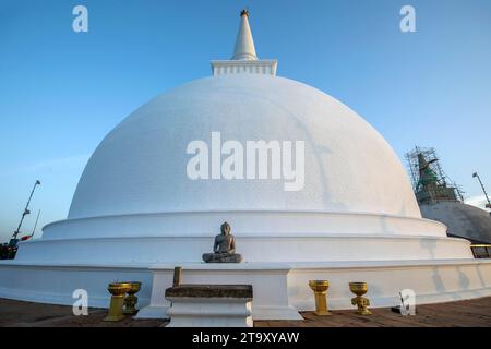 MHINTALE, SRI LANKA - 20. AUGUST 2023 : der Sonnenuntergang über der Maha Seya (Stupa) und der Buddha-Statue in Mihintale in Sri Lanka. Stockfoto