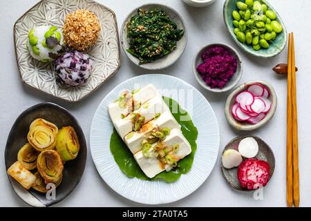 Japanisches Mittagessen mit Seidentofu, Onigiri, Spinatgomae, Miso-Lauch und eingelegtem Gemüse Stockfoto