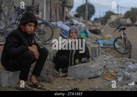 Khan Yunis, Palästinensische Gebiete. November 2023. Palästinenser schauen sich die Zerstörung im Dorf Khuza·a nahe dem Grenzzaun zwischen Israel und dem südlichen Gazastreifen während des vorübergehenden Waffenstillstands zwischen Israel und Hamas an. Quelle: Mohammed Talatene/dpa/Alamy Live News Stockfoto