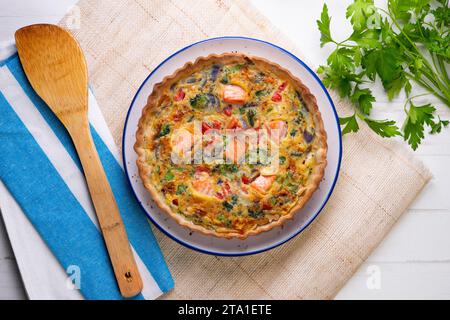 Traditionelle Lachsquiche mit Brokkoli und Gemüse. Stockfoto
