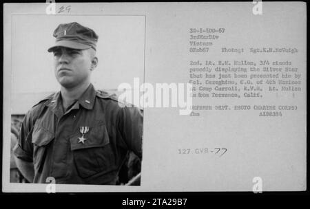 Bildunterschrift: Lieutenant R. Muilen aus Torrance, Kalifornien, zeigt stolz den Silver Star, den ihm Colonel Cereghino, Commanding Officer der 4. Marines in Camp Carroll, RVN, verliehen hat. Die Zeremonie fand am 8. Februar 1967 während des Vietnamkrieges statt. Fotograf: Sergeant K.B. McVeigh. DOD-Foto (Marine Corps) A188384 127. Stockfoto