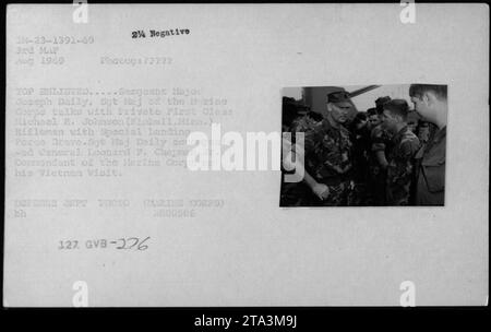 General Leonard F. Chapman Jr., Kommandant des Marinekorps, begleitet von Sergeant Major Joseph Daily, spricht mit dem privaten First Class Michael R. Johnson, einem Schützling der Special Landing Force Dravo. Dieses Foto wurde während des Besuchs von General Chapman in Vietnam im August 1969 aufgenommen." Stockfoto