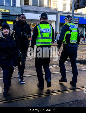 Polizei von Schottland Polizeibeamte benutzen Eine Fußgängerüberfahrt, während sie Princes Street, Edinburgh, Großbritannien, patrouillieren Stockfoto