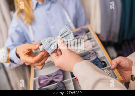 Kunde mit hellblauer Schleife, mit Schneiderhandführung Stockfoto