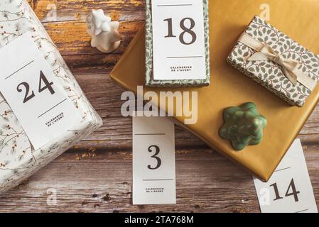 Overhead-Ansicht von Geschenken für einen Adventskalender neben Weihnachtsschmuck Stockfoto