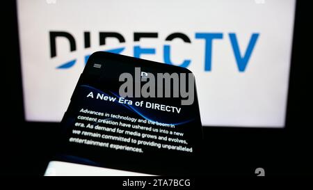 Smartphone mit Webseite des US-amerikanischen Fernsehverteilers DirecTV LLC vor der Business-Webseite. Fokussieren Sie sich oben links auf der Telefonanzeige. Stockfoto