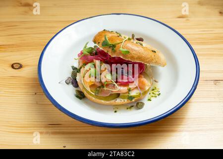 Nahaufnahme des geräucherten Lachs-Bagel-Sandwiches auf Holzbrett Stockfoto