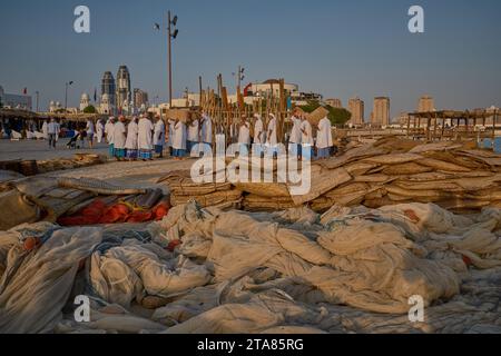 Eine Gruppe traditioneller arabischer Fischer, die im Kulturdorf Katara in Doha, Katar, den Sonnenuntergang während des 13. Traditionellen Dhow-Festivals in Katara, aufführen Stockfoto