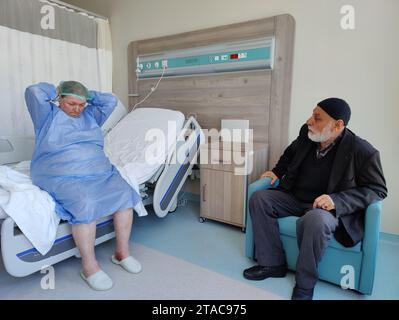 Eine ältere Patientin, die auf eine Operation am offenen Herzen wartet, und ihr Mann warten ängstlich im Patientenzimmer vor der Operation. Stockfoto