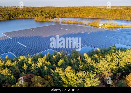 Eine Reihe von Solarpaneelen, die in einem großen Teich schwimmen und Strom aus Sonnenlicht erzeugen Stockfoto