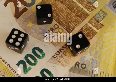 Drei Würfel auf neue 200-Euro-Banknoten, Nahaufnahme. Stockfoto