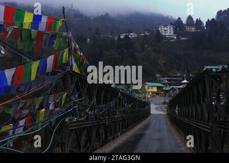 Brücke über den Fluss Lachung Chu mit buddhistischen Gebetsfahnen, wunderschöne Lachung ist ein Tor zum Norden von sikkim, umgeben von himalaya und Wald, indien Stockfoto