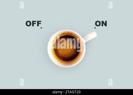Köstlicher Kaffee mit einem lächelnden Gesicht auf blauem Hintergrund, Einschalten. Energieschalter, Konzept. Guten Morgen, kreative Idee Stockfoto