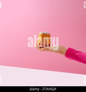Die Hand einer Frau hält einen Cupcake in der Hand Stockfoto