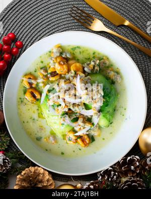 Ceviche mit Cockles und Avocado. Weihnachtsessen werden auf einem Tisch serviert, der mit Weihnachtsmotiven dekoriert ist. Stockfoto