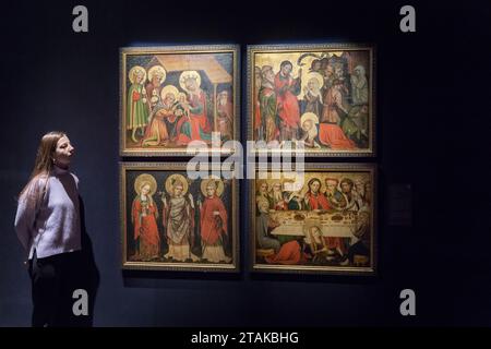 LONDON, VEREINIGTES KÖNIGREICH - 01. DEZEMBER 2023: Ein Mitarbeiter der Galerie betrachtet vier Tafeln aus dem Hildesheimer Magdalene Altarstück (a) die Anbetung der Könige; (b) drei Heiligen: Maria Magdalena, Augustinus und Livinus; (c) die Erziehung des Lazarus; (d) das Abendmahl im Haus des Simon des Pharisäers (Schätzung: £500.000 - 700.000) während eines Fotoanrufs im Auktionshaus Sotheby's, bei dem die Highlights der Old Masters Week Sales in London, Großbritannien, am 1. Dezember 2023 vorgestellt werden. Die Masters Week Evening-Angebote im Dezember erstrecken sich vom frühen 15. Bis zum frühen 20. Jahrhundert und bieten eine breite Auswahl Stockfoto