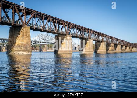 Alte Eisenbahnbrücke, umgebaut in einen Fußweg - Tennessee River in Florenz, Alabama, Herbstlandschaft Stockfoto