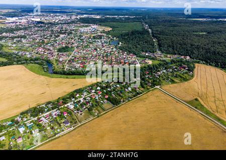 Blick aus einer hohen Höhe von ländlichen und ländlichen Gebäuden umgeben von Feldern und Wäldern Stockfoto