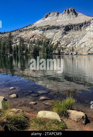 Der Mount Hoffman ragt hoch und spiegelt sich in den Gewässern des May Lake, Yosemite National Park, Kalifornien Stockfoto