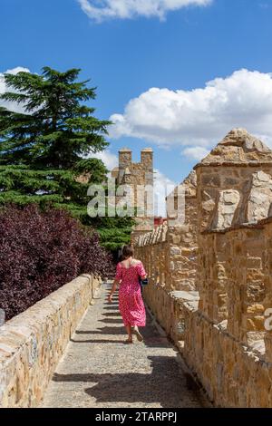 Frau, die auf den Festungsmauern der spanischen Stadtmauer Avila in der autonomen Gemeinde Kastilien und León Spanien spaziert Stockfoto