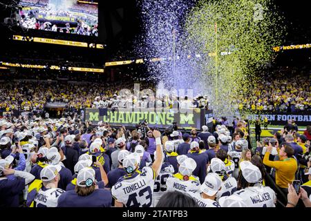 Indianapolis, Indiana, USA. Dezember 2023. Die Spieler der Michigan Wolverines feiern, wenn Konfetti fällt, nachdem sie das Spiel der Big Ten Championship zwischen den Iowa Hawkeyes und den Michigan Wolverines im Lucas Oil Stadium in Indianapolis, Indiana, gewonnen haben. (Kreditbild: © Scott Stuart/ZUMA Press Wire) NUR REDAKTIONELLE VERWENDUNG! Nicht für kommerzielle ZWECKE! Stockfoto