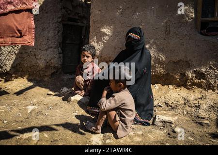 Eine traurige Witwe in Not, begleitet von ihren Kindern, repräsentiert afghanische Familien mit Armut und Not | Flüchtlingsfamilie. Stockfoto