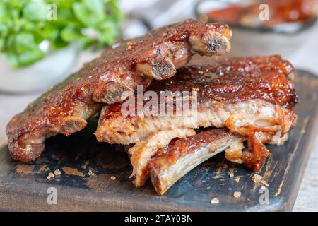 Heiße gegrillte Rippchen von einem hölzernen Schneidebrett Stockfoto