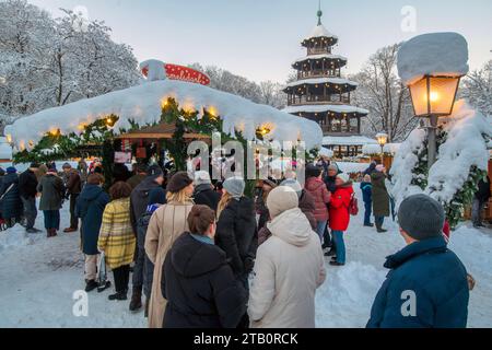 Winteridyllille beim Weihnachtsmarkt am Chinesischen Turm, München, Dezember 2023 Deutschland, München, Dezember 2023, viele Münchner besuchen den Weihnachtsmarkt am Chinesischen Turm, Schlange am Glühweinstand, erster Advent, Sonntagnachmittag, alles tief verschneit, Minustemperaturen um die -10 Grad, klirrende Kälte, Blaue Stunde, Dämmerung, Englischer Garten, Adventszeit, Weihnachtszeit, weihnachtlich, Gastronomie, Winter, bayerisch, Bayern, *** Winteridyllik auf dem Weihnachtsmarkt am Chinesischen Turm, München, Dezember 2023 Deutschland, München, Dezember 2023, viele Münchner besuchen das Chris Stockfoto