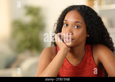 Porträt einer ernsten schwarzen Frau zu Hause, die dich ansieht Stockfoto