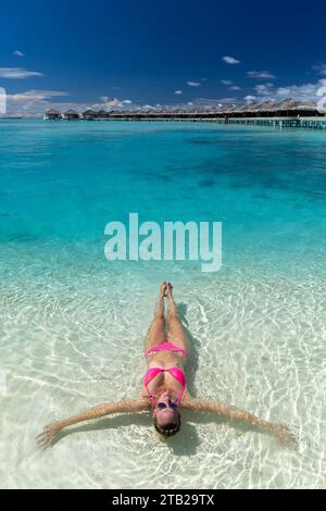 Blonde weiße Frau mit rosafarbenem Bikini im Anantara Dhigu und Vela Luxushotel Maldives Stockfoto