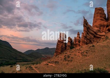 Wunderschöner Trakt Zhaman uy in den Bergen Kasachstans auf Platey Assy. Fantastische Tonreste von roter Farbe bei Sonnenuntergang Stockfoto