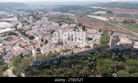 Luftpanorama der mittelalterlichen, von Mauern umgebenen Stadt Óbidos mit Schloss und historischen weißen Häusern im Zentrum Portugals Reiseziel. August 2022 Stockfoto