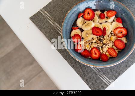 Eine Schüssel frisch zubereitetes Acai-Eis mit frischem Obst und Haferbrei auf einem Tisch Stockfoto