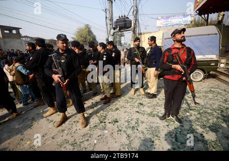 Peshawar, Peshawar, Pakistan. Dezember 2023. Zersplittertes Glas bedeckt den Boden, während pakistanische Sicherheitsbeamte am 5. Dezember 2023 den Ort der Explosion eines improvisierten Sprengstoffs (IED) an einem Straßenrand in Peshawar, Pakistan, untersuchen. Mindestens sieben Menschen, darunter drei Kinder, wurden bei einer Explosion auf Polizeipersonal verletzt und ereigneten sich auf der Warsak-Straße in Peshawar, sagten Polizei- und Krankenhausbeamte. Kashif Aftab Abbasi sagte, dass das Fahrzeug der Machnigate Polizeiwache auf Routinepatrouille war, als die Bombe explodierte. Quelle: ZUMA Press, Inc./Alamy Live News Stockfoto