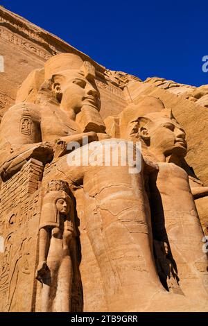 Nahaufnahme von zwei der Ramses II-Statuen, die aus dem Berghang vor dem Großen Sonnentempel von Abu Simbel gemeißelt wurden; Abu Simbel, Nubien, Ägypten Stockfoto