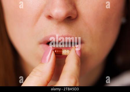 Nahaufnahme der jungen Frau nimmt Pille. Stockfoto