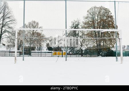 A football goal covered in snow. The concept of the end of the football season and the end of the football leagu. Stockfoto