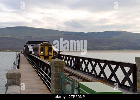 Barmouth, Wales, 6. Dezember 2023. Die berühmte 164 Jahre alte Barmouth Bridge wurde diese Woche nach einer dreimonatigen Schließung für den Wiederaufbau wieder für Züge eröffnet. Das Gebäude wurde von Network Rail und den Bauunternehmen Alun Griffiths komplett umgebaut und ersetzt die Stahlspanen durch genaue Nachbildungen der Originale. Die Brücke liegt an der Cambrian Coast Railway Line, die oft als eine der schönsten Eisenbahnstrecken Großbritanniens gilt. G.P. Essex/Alamy Live News Stockfoto