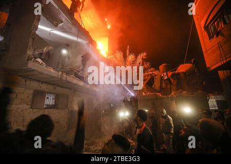 Rafah, Gaza. Dezember 2023. Palästinenser suchen nach Opfern inmitten der Trümmer eines schwelenden Hauses nach einem israelischen Streik in Rafah im südlichen Gazastreifen am Mittwoch, den 6. Dezember 2023. Israel hat seine Offensive gegen die im belagerten südlichen Gazastreifen eingeschlossenen Zivilisten ausgedehnt, so die UNO. Foto: Ismael Mohamad/UPI Credit: UPI/Alamy Live News Stockfoto