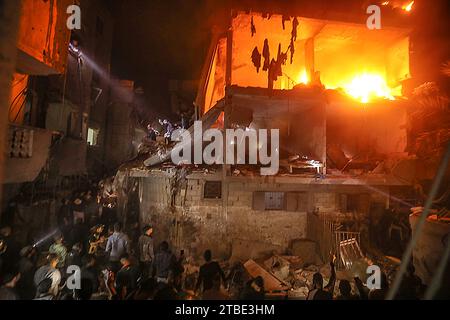 Rafah, Gaza. Dezember 2023. Palästinenser suchen nach Opfern inmitten der Trümmer eines schwelenden Hauses nach einem israelischen Streik in Rafah im südlichen Gazastreifen am Mittwoch, den 6. Dezember 2023. Israel hat seine Offensive gegen die im belagerten südlichen Gazastreifen eingeschlossenen Zivilisten ausgedehnt, so die UNO. Foto: Ismael Mohamad/UPI Credit: UPI/Alamy Live News Stockfoto