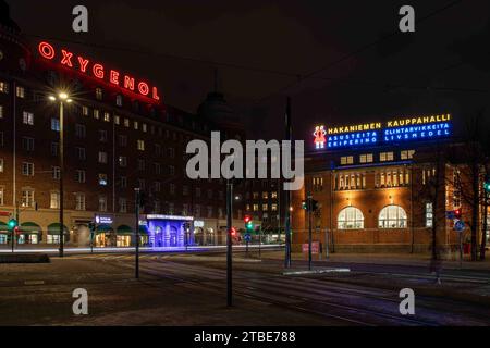 Langzeitbelichtung von Neonlichtern von Oxygenol und Hakaniemen kauppahalli nach Einbruch der Dunkelheit im Bezirk Hakaniemi in Helsinki, Finnland Stockfoto