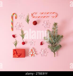 Kreatives Layout aus winterlichen Dingen auf pastellrosa Hintergrund. Flache Lagen. Stockfoto