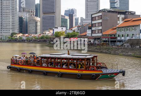 Bumboat mit Touristen auf einer Bootstour auf dem Singapur River, Singapur Stockfoto