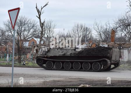 Orichhiv, Ukraine. Dezember 2023. Ein gepanzertes ukrainisches Militärfahrzeug, das auf der Straße entlang der privaten Häuser vorbeifährt, die durch russische Bombenangriffe in Orichschiw zerstört wurden. Der ukrainische Präsident Wolodymyr Zelenskyj sagte, er habe eine Erweiterung der Verteidigungsanlagen über das Schlachtfeld angeordnet. Nach dem Scheitern der ukrainischen Gegenoffensive von 2023 könnte Zelenskyj die Ankündigung signalisieren, dass Kiew beabsichtigt, 2024 eine defensive Haltung einzunehmen. Wenn man sich hineingräbt, könnte die Ukraine dabei helfen, künftige russische Offensiven abzuwehren, während Kiew mehr Truppen für die Ausbildung im Westen ersparen kann. (Kreditbild: © Andr Stockfoto