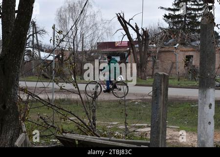 Orichhiv, Ukraine. Dezember 2023. Ein Anwohner fährt mit dem Fahrrad die Straße entlang der privaten Häuser, die durch russische Bombardierungen in Orichschiv zerstört wurden. Der ukrainische Präsident Wolodymyr Zelenskyj sagte, er habe eine Erweiterung der Verteidigungsanlagen über das Schlachtfeld angeordnet. Nach dem Scheitern der ukrainischen Gegenoffensive von 2023 könnte Zelenskyj die Ankündigung signalisieren, dass Kiew beabsichtigt, 2024 eine defensive Haltung einzunehmen. Wenn man sich hineingräbt, könnte die Ukraine dabei helfen, künftige russische Offensiven abzuwehren, während Kiew mehr Truppen für die Ausbildung im Westen ersparen kann. (Bild: © Andriy Andriyenko/SO Stockfoto