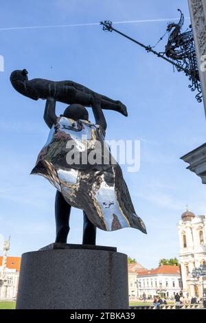 Eine künstlerische Bronzeskulptur, die zwei Männer zeigt, die miteinander interagieren, während jeder ein Objekt in der Hand hält Stockfoto